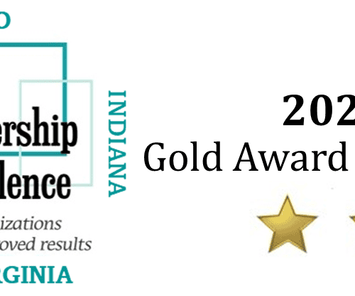 The Partnership for Excellence 2023 Gold Award Recipient logo with two gold stars