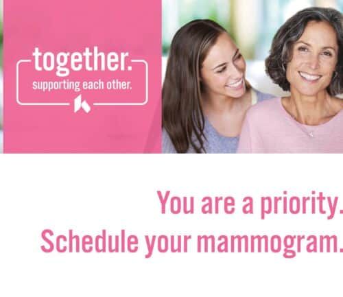 Two women embracing and smiling with text promoting mammogram scheduling