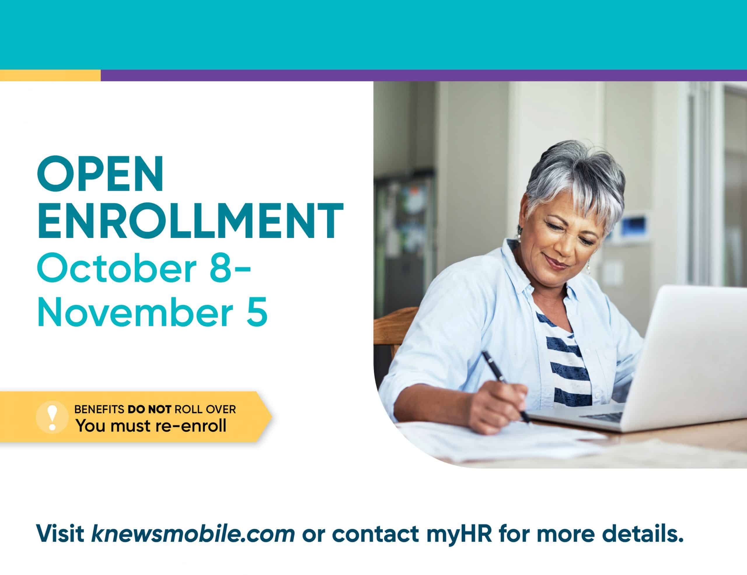Woman with gray hair writing while looking at laptop during open enrollment period