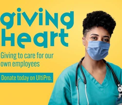 Healthcare worker in scrubs and mask promotes employee giving campaign on yellow background