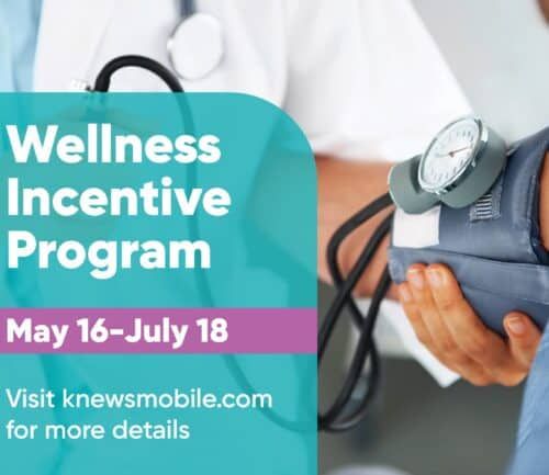 Healthcare provider taking patient's blood pressure during wellness screening appointment