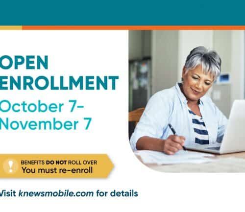Woman writing notes while using laptop during open enrollment period October 7-November 7