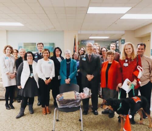 Group of Kettering Health staff members posing together in hospital lobby