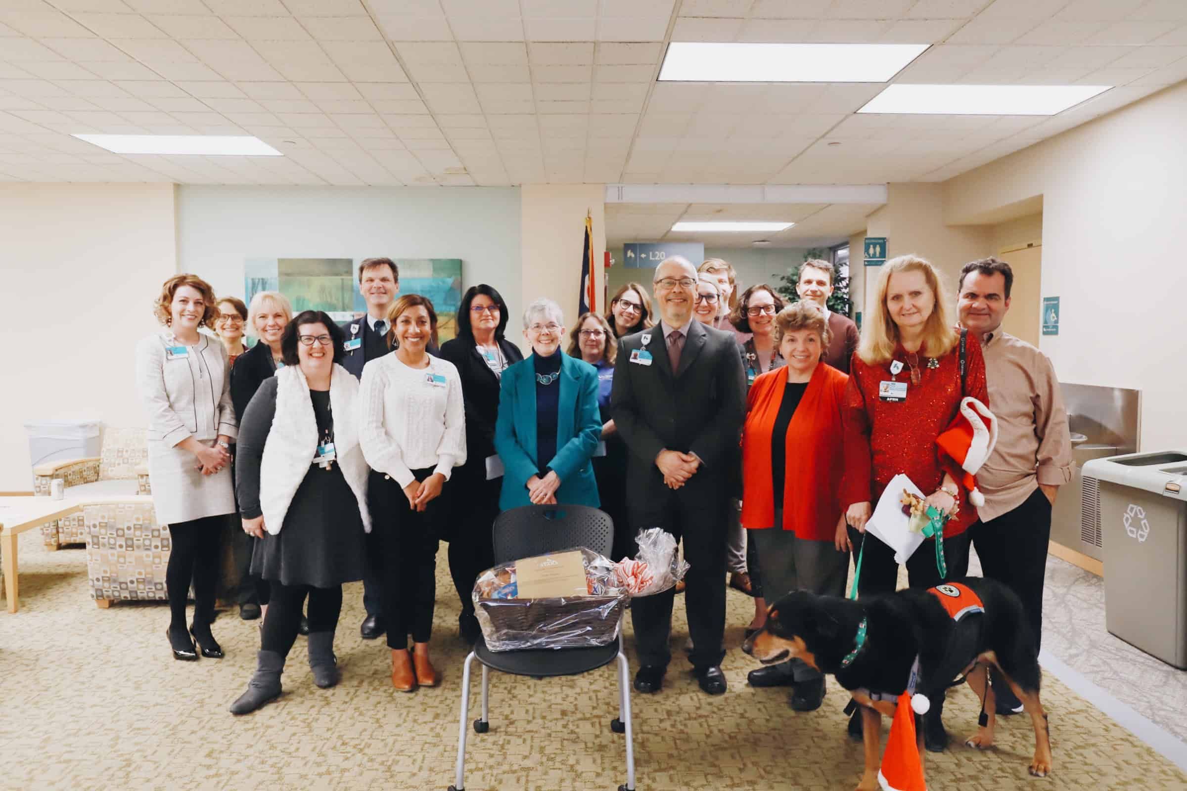 Group of Kettering Health staff members posing together in hospital lobby