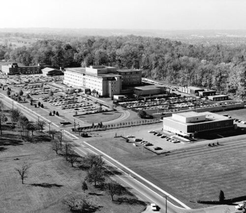 Aerial view of Kettering Medical Center campus with hospital buildings and parking lots, 1964