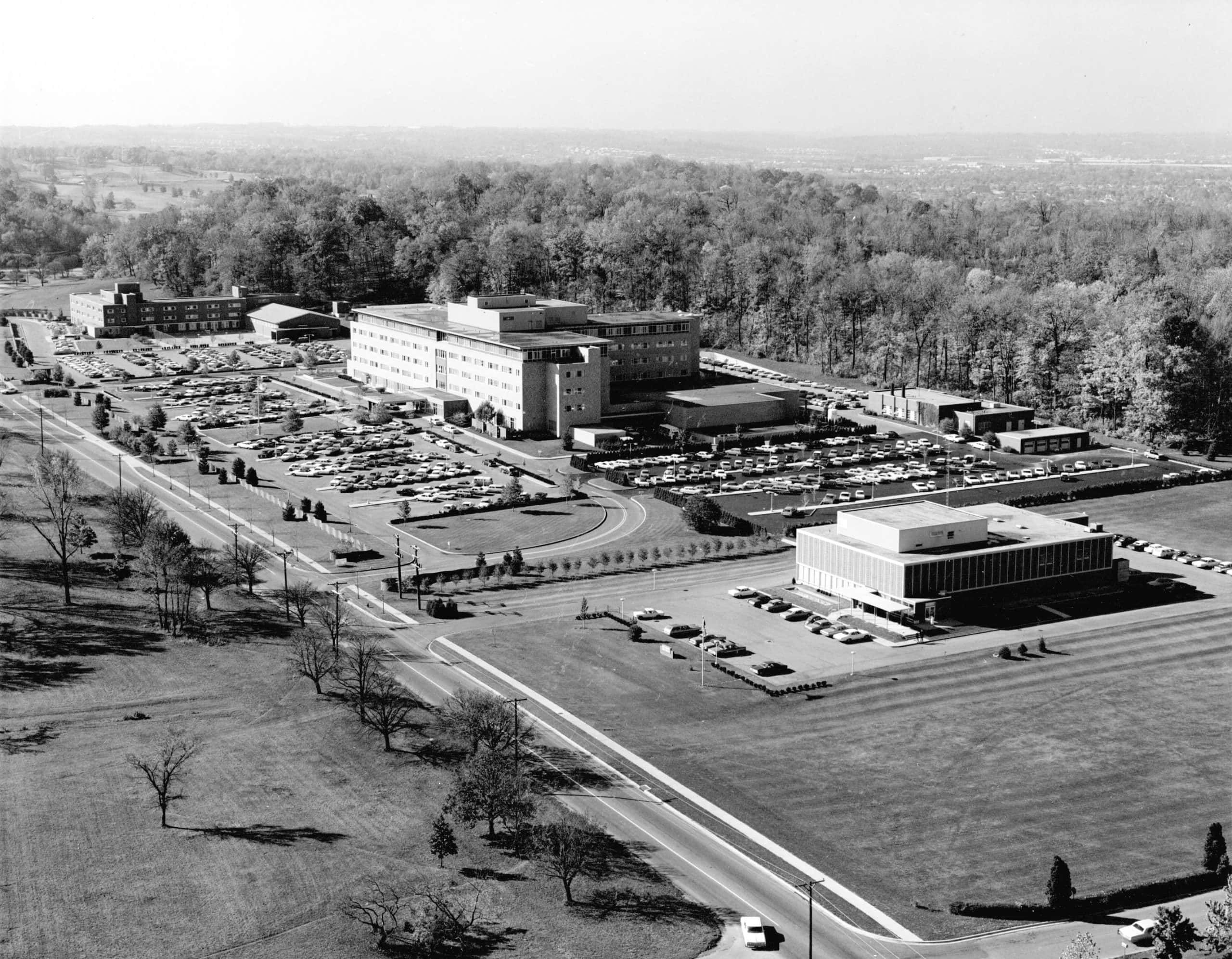 Aerial view of Kettering Medical Center campus with hospital buildings and parking lots, 1964