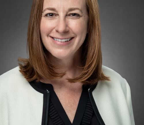 Professional headshot of Wendi Barber wearing white blazer and black blouse