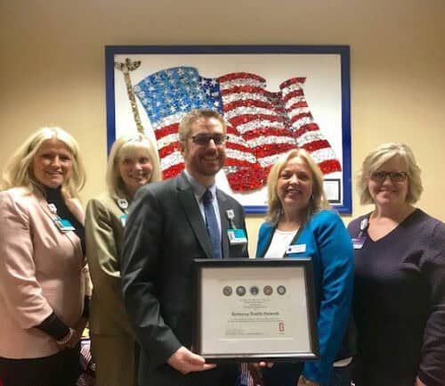 Healthcare executive receives award certificate from Blue Star Mothers organization members