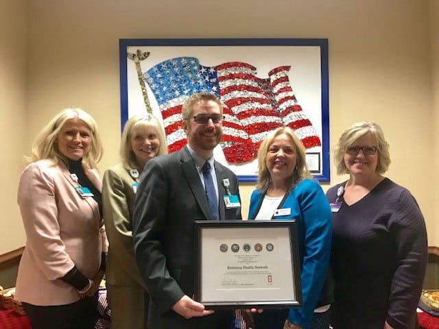 Healthcare executive receives award certificate from Blue Star Mothers organization members