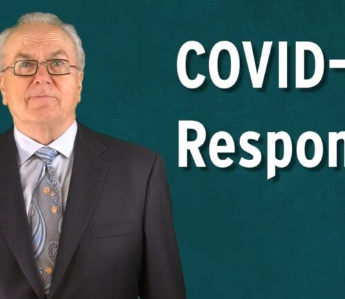 Professional man in suit and glasses presenting COVID-19 Response information
