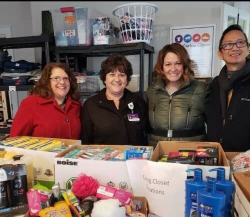Four volunteers organizing donated supplies and toiletries at Kettering Health's Caring Closet