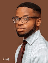 Professional headshot of Chidiebere Ibe in glasses and checkered shirt with tie