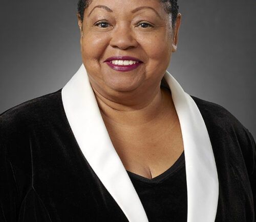 Professional headshot of Cynthia Hammond wearing black blazer with white lapels