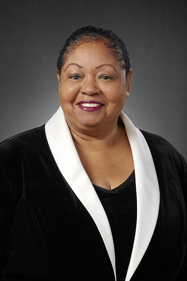 Professional headshot of Cynthia Hammond wearing black blazer with white lapels