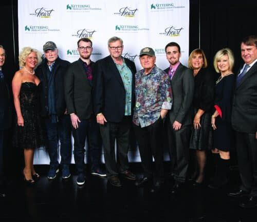 Group of formally dressed people posing together at Kettering Health Foundation charity event