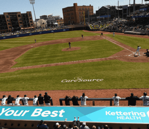 Baseball game at stadium with Kettering Health "Be Your Best" banner visible