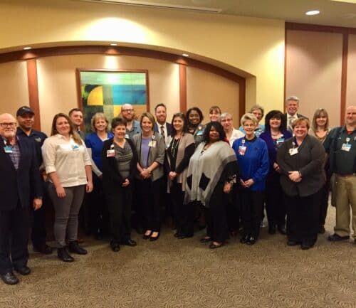 Group of healthcare employees posing together at Employee of the Month recognition luncheon.