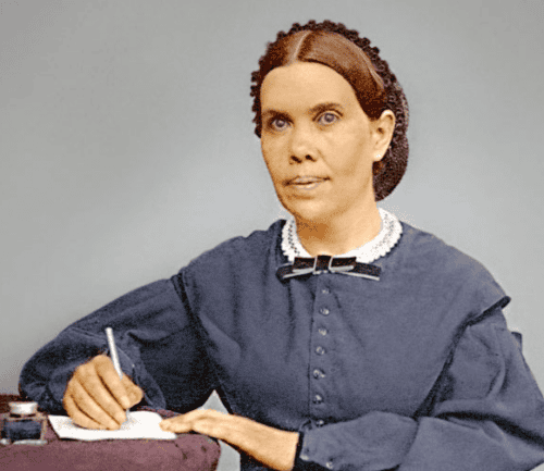 Historical figure in 19th century dress writing at desk with pen and paper