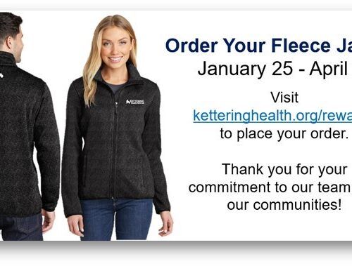 Man and woman modeling dark fleece jackets with Kettering Health logo and ordering information
