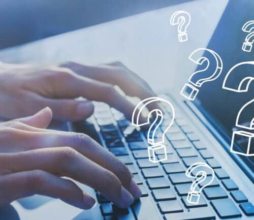 Hands typing on laptop keyboard with floating question mark icons overlay