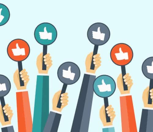 Multiple hands holding up circular signs with thumbs up icons in various colors