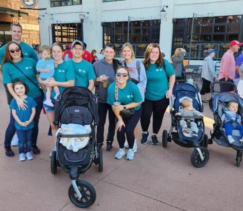 Group of families with strollers and children participating in community heart walk event