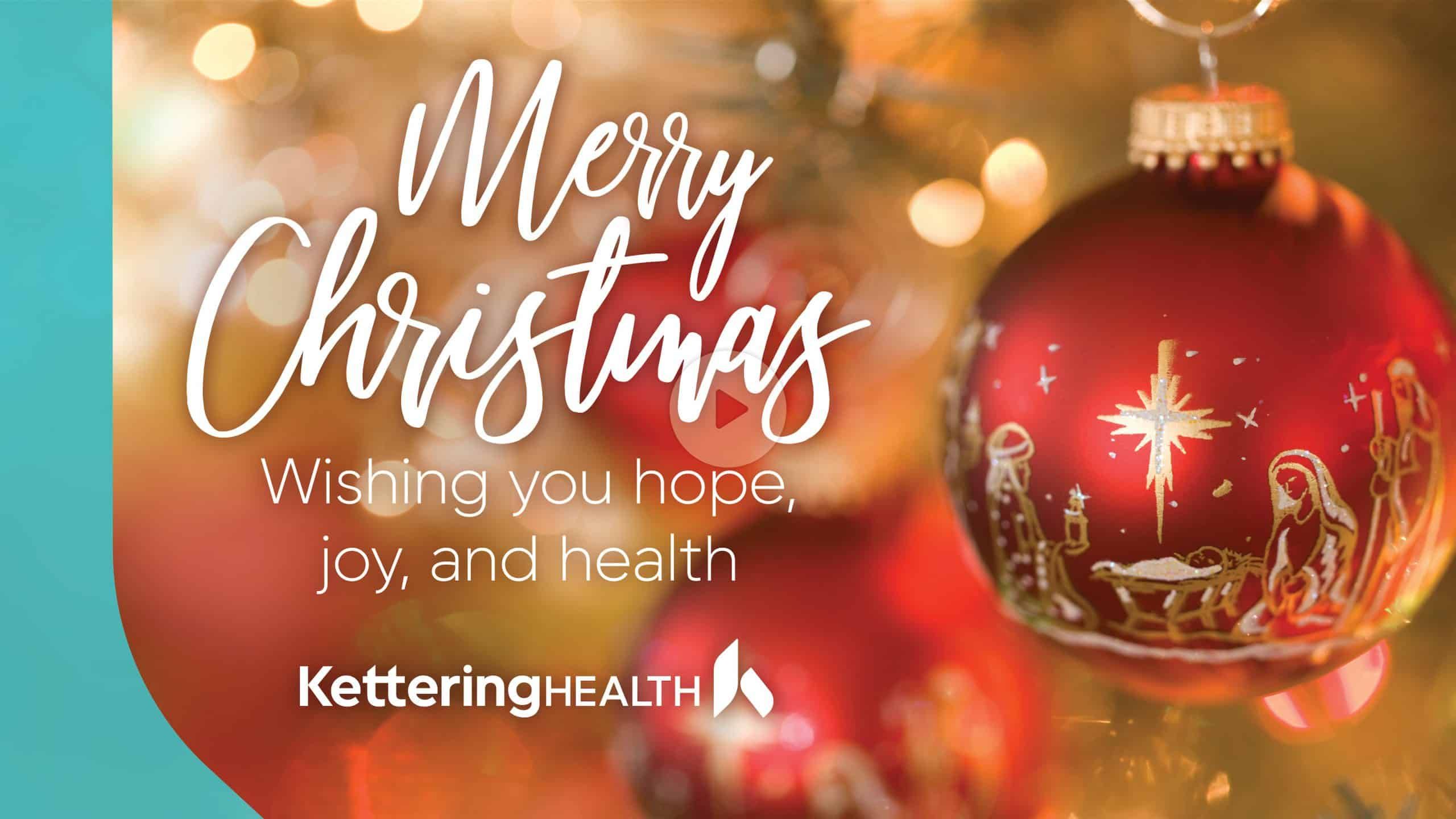 Christmas ornament with nativity scene beside "Merry Christmas" text and Kettering Health logo