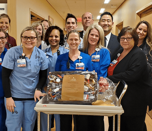 Healthcare team celebrates employee of the month award with gift basket presentation