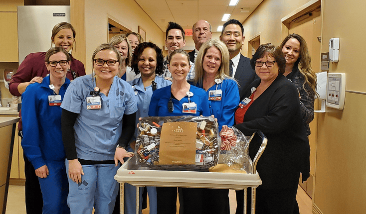 Healthcare team celebrates employee of the month award with gift basket presentation