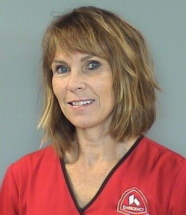 Professional headshot of healthcare provider in red Kettering Health scrubs