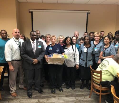 Large group of Kettering Health employees posing together during employee recognition ceremony