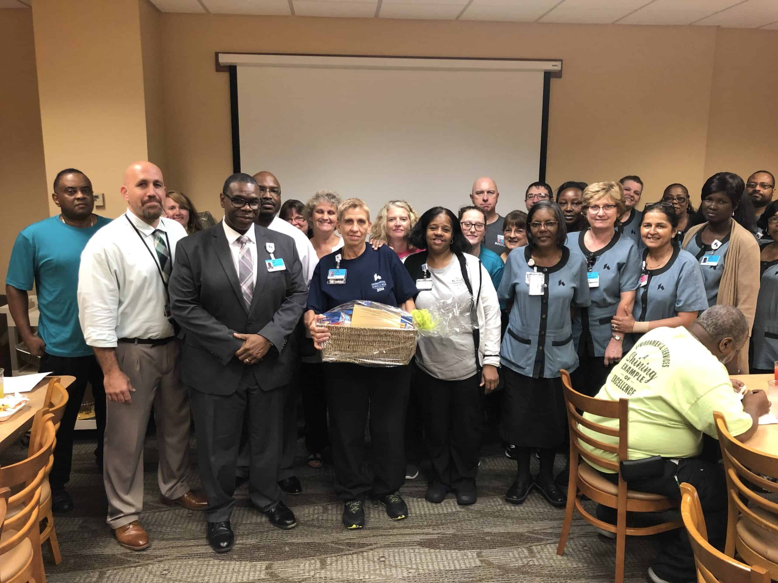Large group of Kettering Health employees posing together during employee recognition ceremony