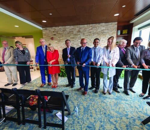 Healthcare officials cutting ribbon at Kettering Health cancer center grand opening ceremony