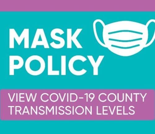 Mask policy banner with face mask icon and COVID-19 transmission levels button