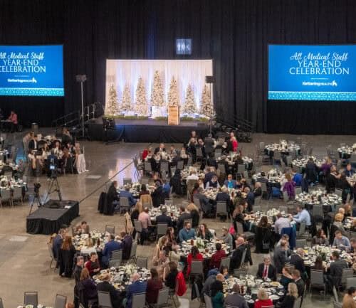 A large room with several tables and a stage