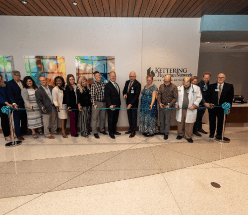 Group of people holding ribbon-cutting ceremony at Kettering Health Middletown facility
