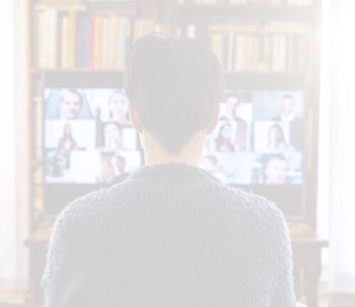 Two people browsing books together in a library or bookstore