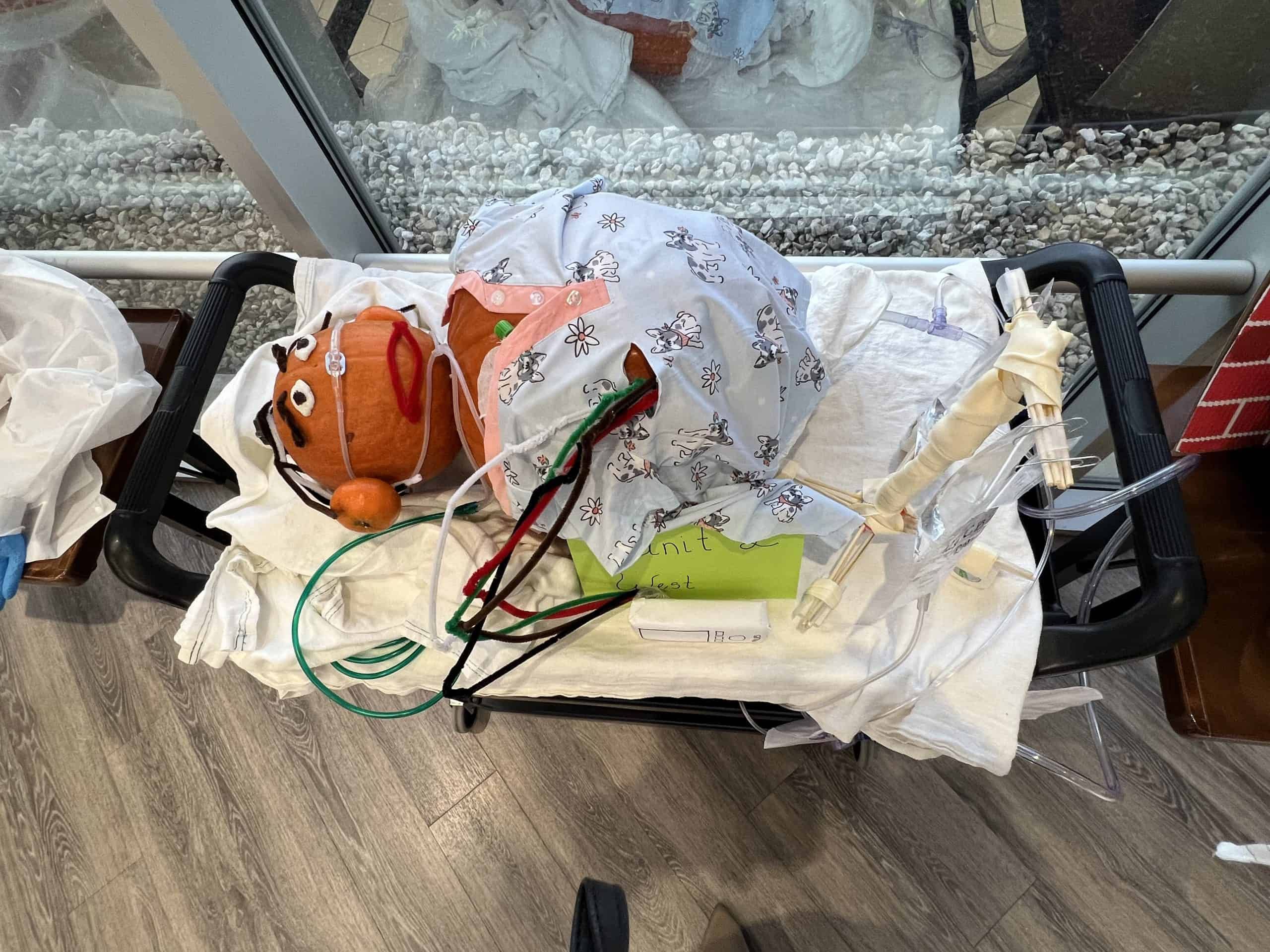 Medical equipment with orange pumpkin-shaped device and tubes in hospital setting