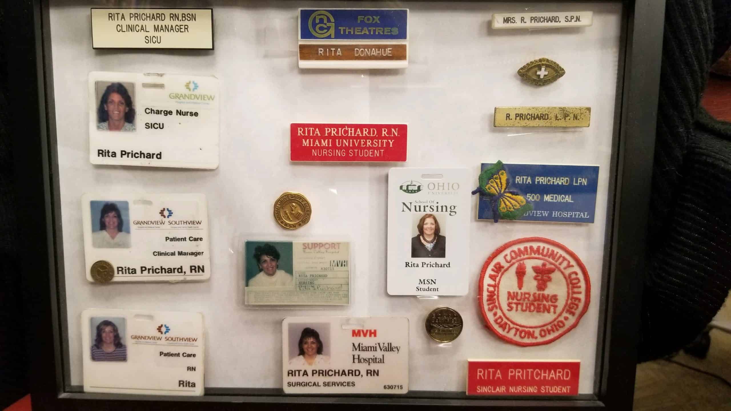 Collection of nursing name badges and ID cards for Rita Prichard displayed in frame