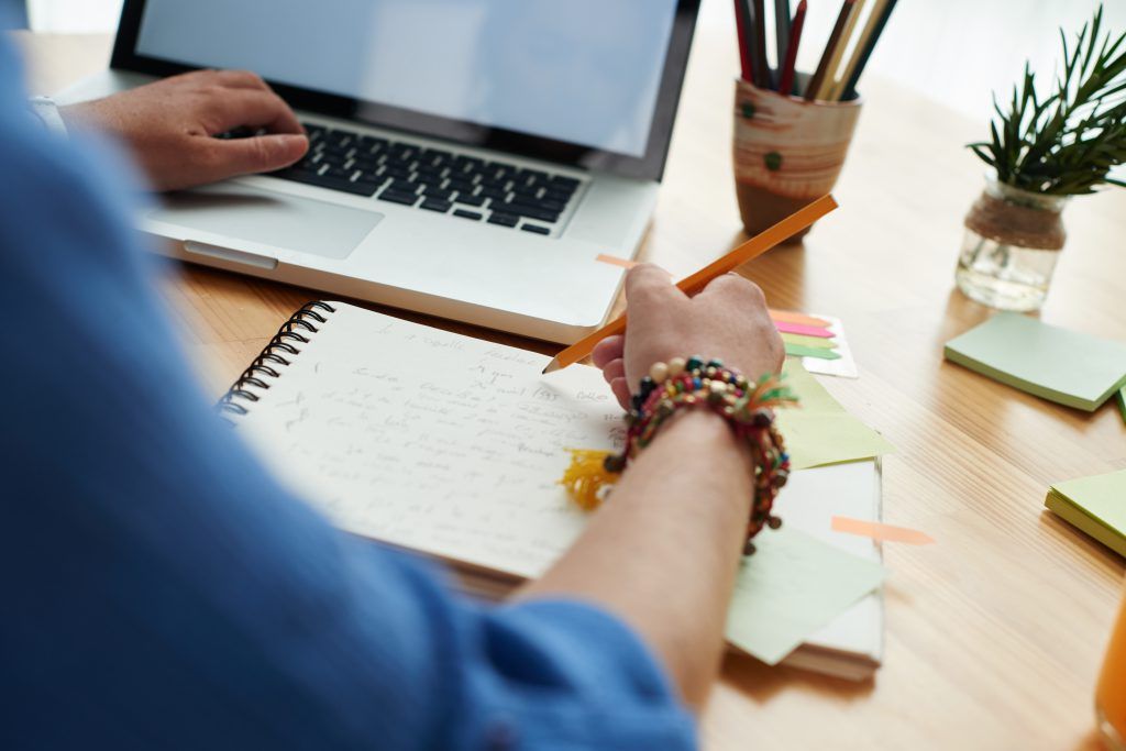 Woman working at a wooden desk