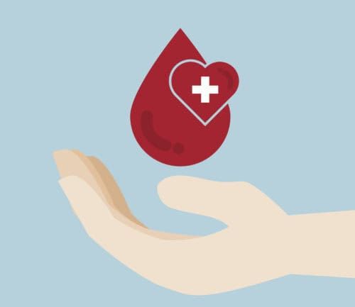 Hand holding red blood drop with heart and medical cross symbol