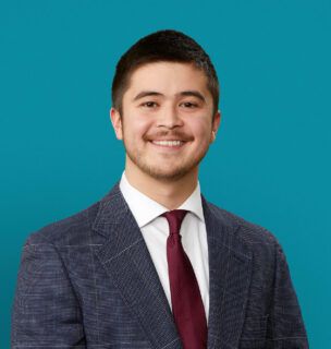 Professional headshot of Chris Wharton, PA-C in suit and tie against teal background