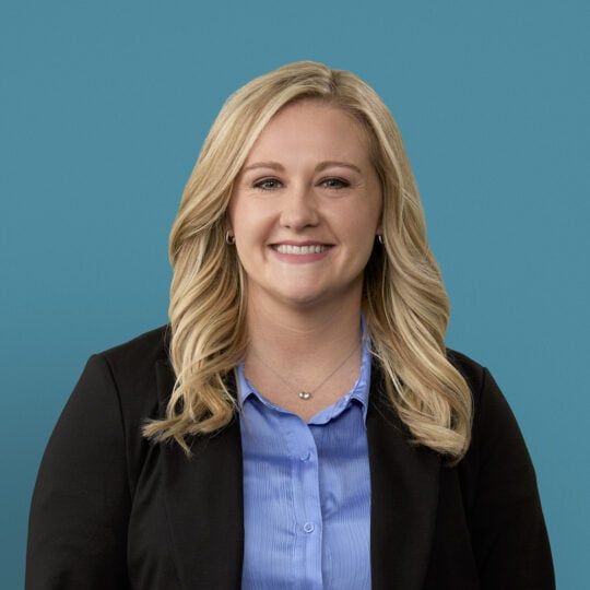 Professional headshot of Cori K. Luthman, PA-C in black blazer and blue shirt