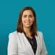Professional headshot of Daniela Rosu, MD in light gray blazer against teal background