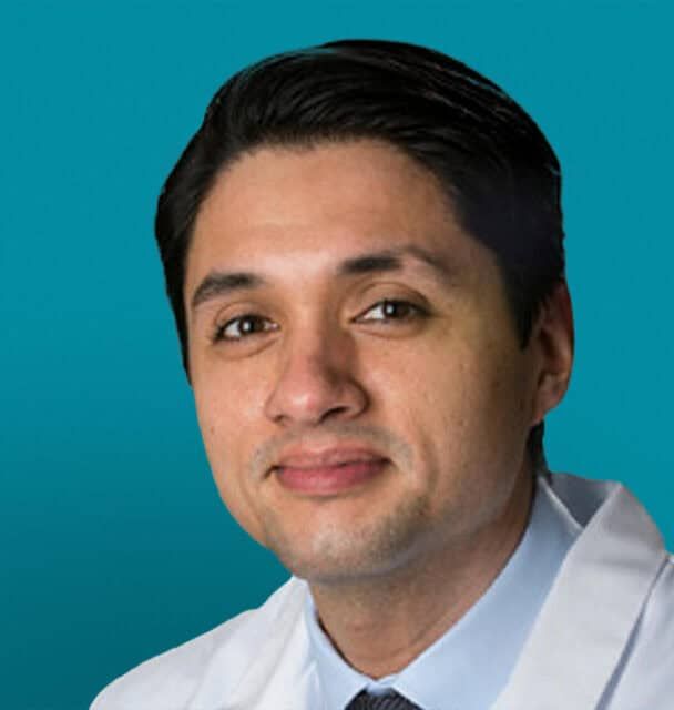 Professional headshot of Juan C. Rojas-Gomez, MD in white medical coat