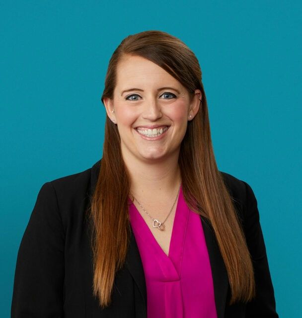 Professional headshot of Lauren Gin, DO in black blazer and pink blouse