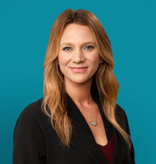 Professional headshot of Mindy Kahlhamer, APRN-CNP in black blazer against teal background