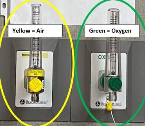 Medical gas outlets showing yellow air valve and green oxygen valve with flow meters.