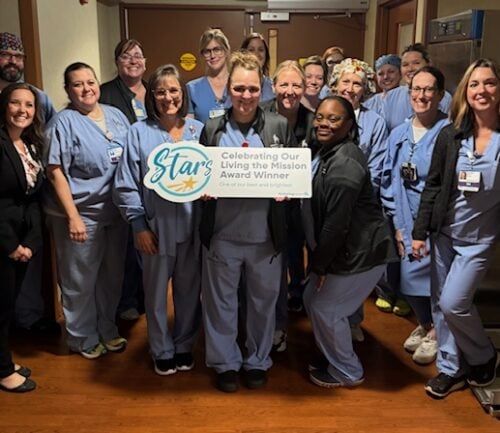 Healthcare team celebrating Angela Pitts' Living the Mission Award Winner recognition