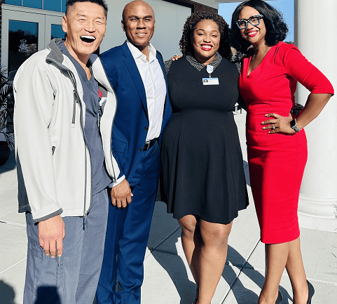 Four diverse healthcare professionals posing together at Kettering Health DEI symposium event.